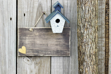 Blank rustic sign with birdhouse and heart