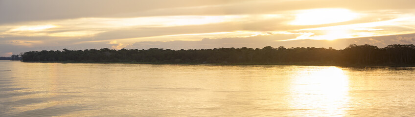 Obraz premium Colorful sunset on the river Amazon in the rainforest, Brazil