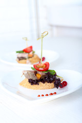 Tasty canapes on wooden table, close up