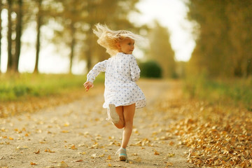 cheerful little girl on the nature of soft light portrait