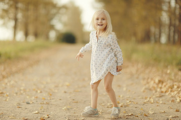 Portrait of a cheerful little girl outside