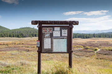 Fototapeta na wymiar Trailhead sign in landscape setting.