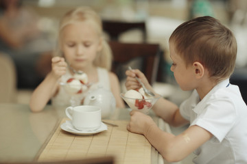 boy and girl a dessert in cafe Love