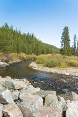 Fototapeta na wymiar River flowing through mountain landscape.