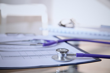 Purple stethoscope on the glass desk