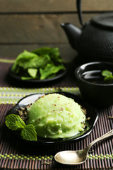 Homemade Green tea ice-cream on bamboo mat, on wooden background