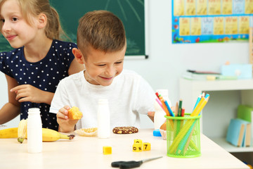 Cute children at lunch time in classroom