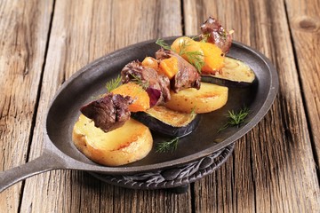 Meat skewer with baked potatoes