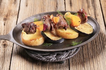 Meat skewer with baked potatoes