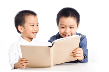 Two Young boy reading book