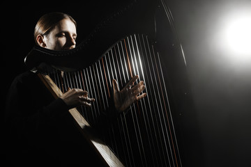 Harp player. Harpist classical musicians