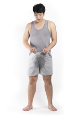 Asian man in grey pajamas with wet crotch