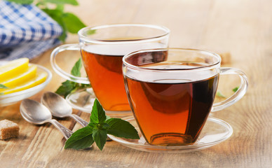 Cups of tea with mint leaves.