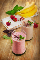 Smoothies with  strawberry and banana on  a wooden table.