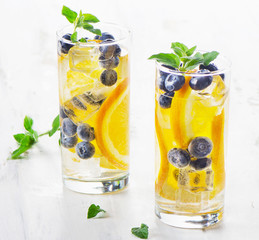 Healthy water with orange and blueberries.