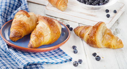 Fresh croissants with blueberries for a breakfast.