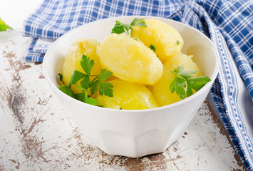 Boiled potatoes in a white bowl.