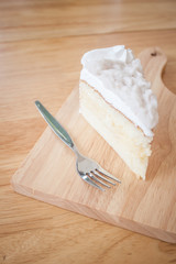 Coconut cake Served on a plate shaped cutting board