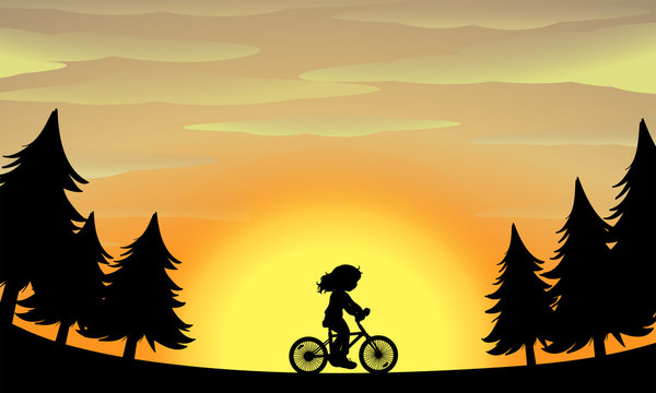 Silhouette girl riding bike in the park