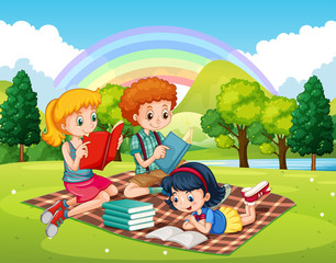 Obraz na płótnie Canvas Children reading books in the park