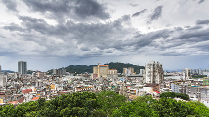 Macau packed houses and city skyline under the cloudy sky. Rich and poor stays close to each other in Macau, China. 
