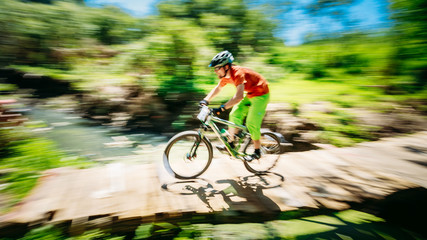 Fototapeta na wymiar Mountain Bike cyclist riding track at sunny day, healthy lifesty