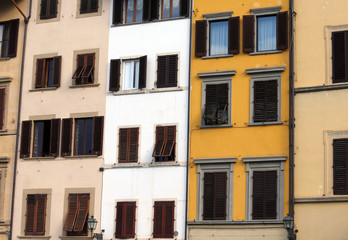 Windows and balcony of a building in a historic Italian square