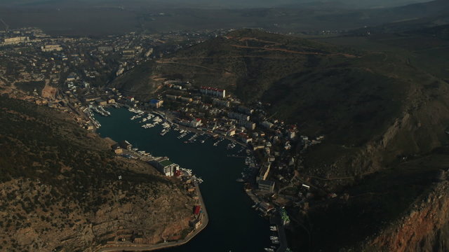 Aerial View: Flight over the Coast. Balaklava bay, Crimea, autumn. Balaklava is a small town on the Black Sea in the south-western tip of the Crimean peninsula. Now is a popular Crimean resort.