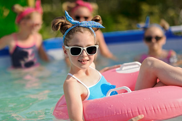 Portrait of children on the pool in summer