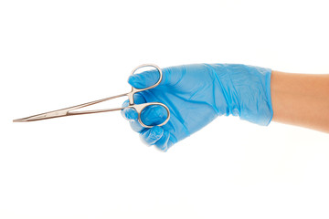 Close up of female doctor's hand in blue sterilized surgical glove with forceps against white background