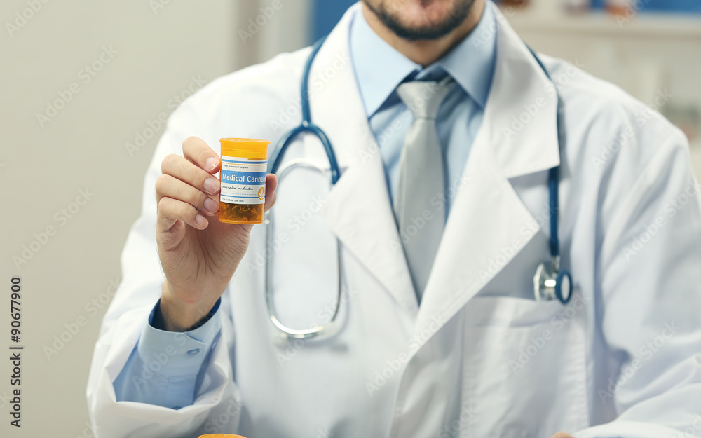 Canvas Prints Doctor holding bottle with medical cannabis close up