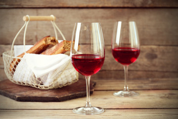Still life of wine and bread on light background