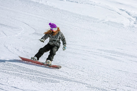 Girl snowboarder on ski track