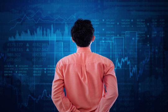 Worker watching at stock exchange graph