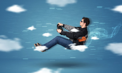 Fototapeta na wymiar Funny racedriver young man driving between clouds concept