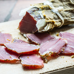 smoked wild boar meat on the wooden board