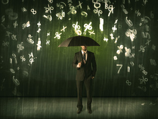 Businessman standing with umbrella and 3d numbers raining concep