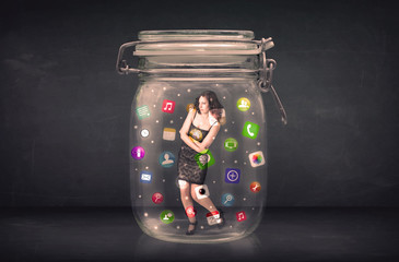 Businesswoman captured in a glass jar with colourful app icons c