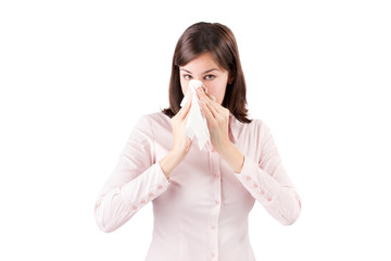 Beautiful young business woman with a cold blowing nose.