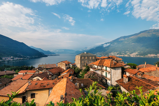  Laghetto di Piona, penincula Olgiasca  in Italy, Alps, Europe. Como lake.  rural mountain landscape with houses and red-tiled roofs.