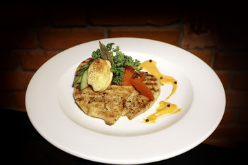 Plate with grilled chicken fillet