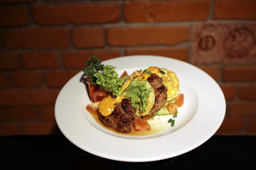 Plate with fried pieces meat and vegetables