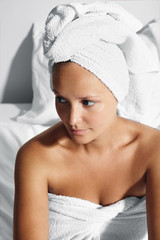 woman after bath sitting on a bed