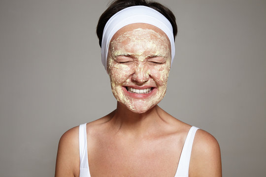 woman have fun making facial treatment