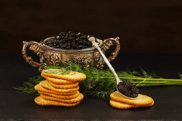 Black caviar served on crackers