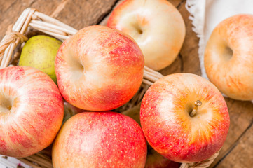 Fresh red apples in a basket. Rustic style