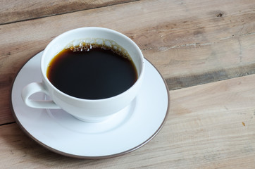 Coffee cup on wood.