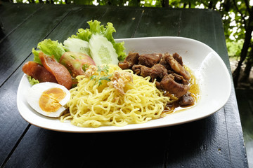 Dry Yellow Noodles with egg, salad, sausage and braised pork