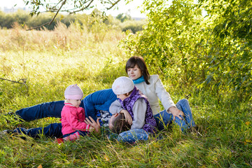 Fototapeta premium Family resting the meadow in autumn