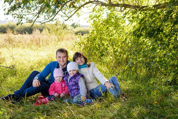 Fototapeta premium Family resting the meadow in autumn